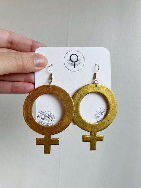 Stora kvinnotecken, örhängen guldiga