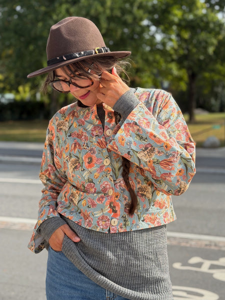 Kort jacka i trikå med milda färger