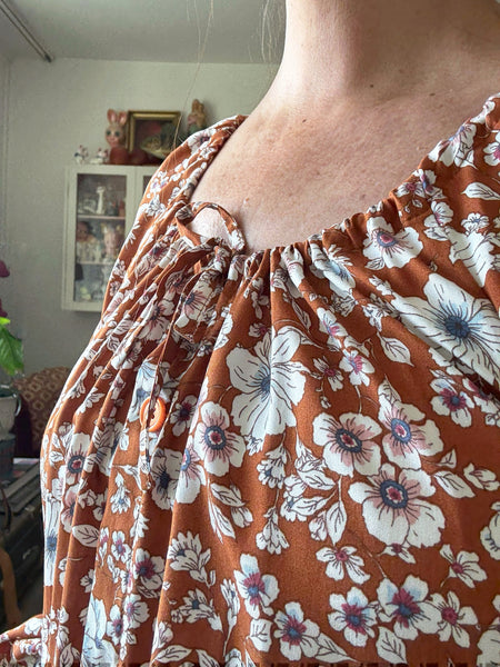 Långklänning i rost med blommor