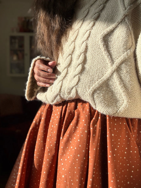 Vid kjol i tegelfärgad bomull med guldprickar